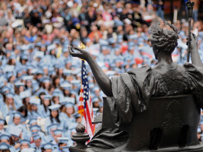 Photo of Columbia University commencement with Alma Mater statue in foreground
