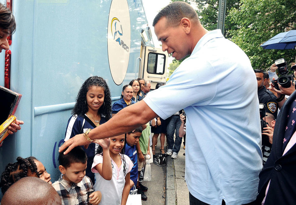 Alex Rodriguez greeting children outside MS 328 and MS 326 in Washington Heights to celebrate the opening of a new dental van