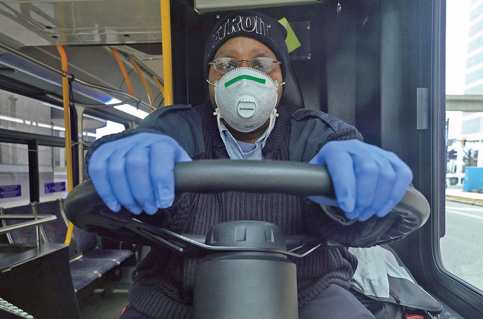 A city bus driver in Detroit wearing a face mask