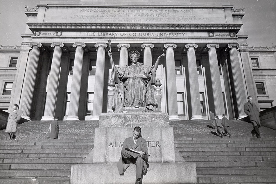 A man reads on Columbia's Low Library steps at the base of the Alma Mater statue in the 1940s