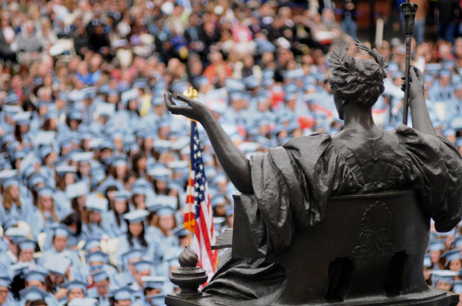 Photo of Columbia University commencement with Alma Mater statue in foreground