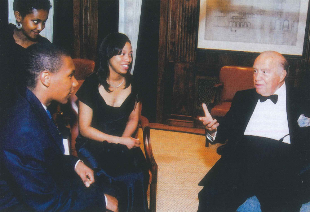 John W. Kluge, during his 90th birthday party at Columbia University, speaks with recipients of Columbia scholarships that he funded