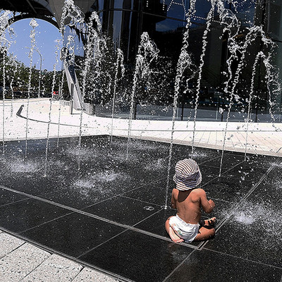 A baby in the fountain outside Kravis Hall, Columbia University