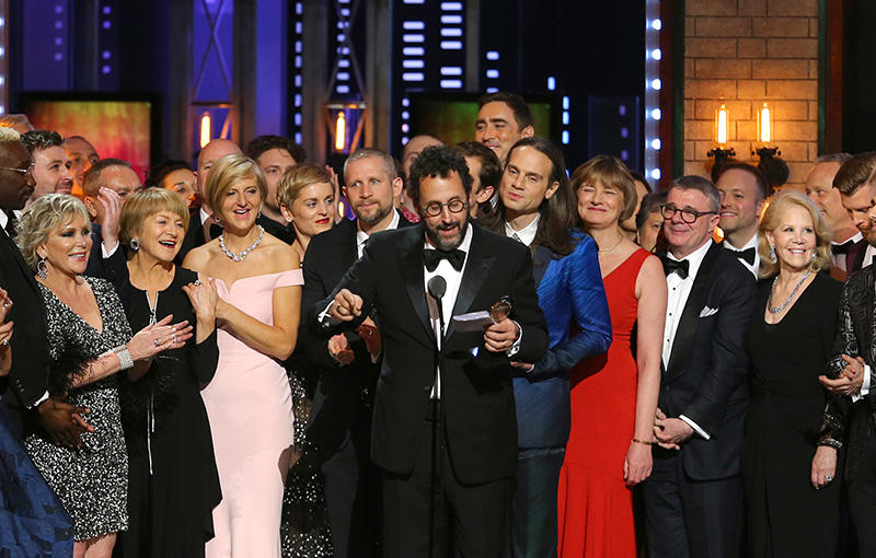 Playwright Tony Kushner, center, and the cast and crew of "Angels in America" accept the award for best revival of a play at the 72nd annual Tony Awards at Radio City Music Hall on Sunday, June 10, 2018, in New York. (Photo by Michael Zorn/Invision/AP)
