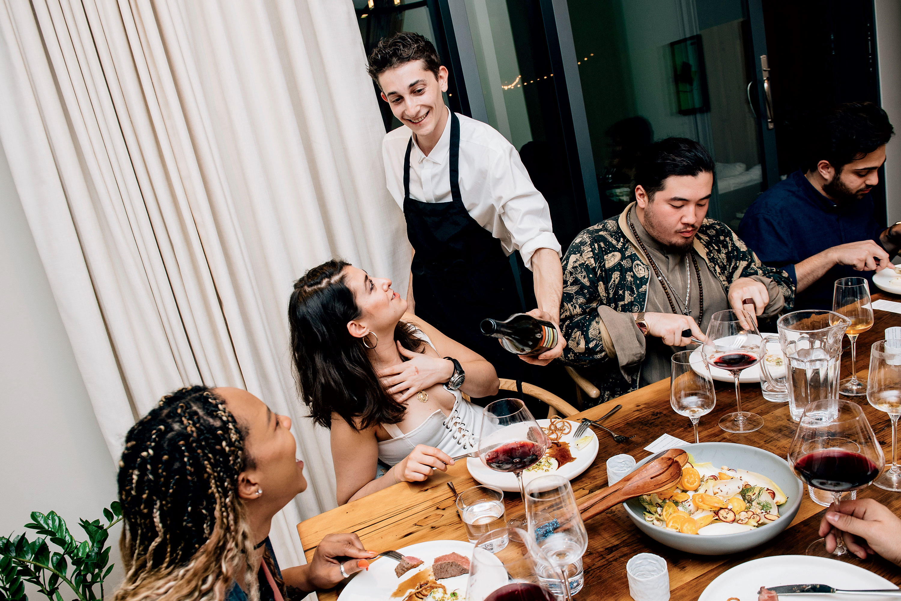 Jonah Reider serving dinner guests