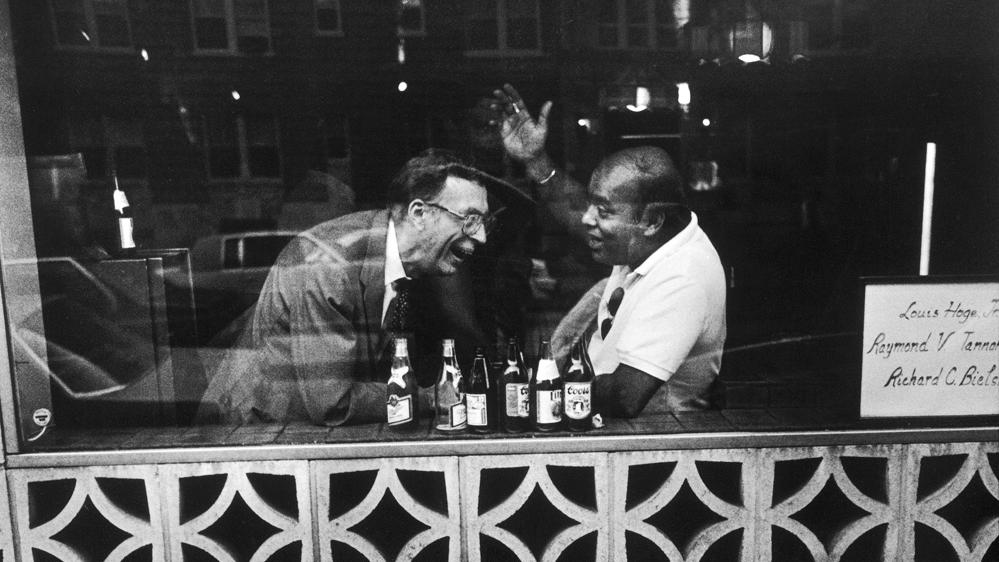 Photograph of two men in a bar by Jack Eisenberg