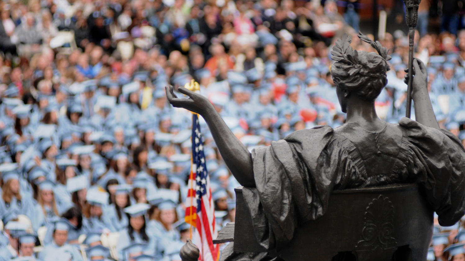 Photo of Columbia University commencement with Alma Mater statue in foreground