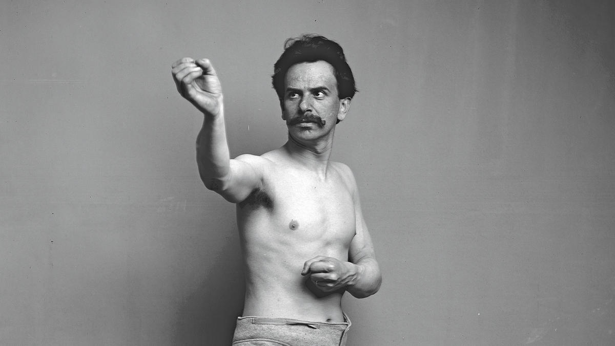 Archive photo of Franz Boas reenacting a Kwakiutl ceremonial dance to assist Smithsonian Institution sculptors building a diorama