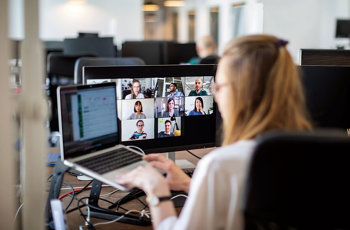 A woman on a Zoom call in an office
