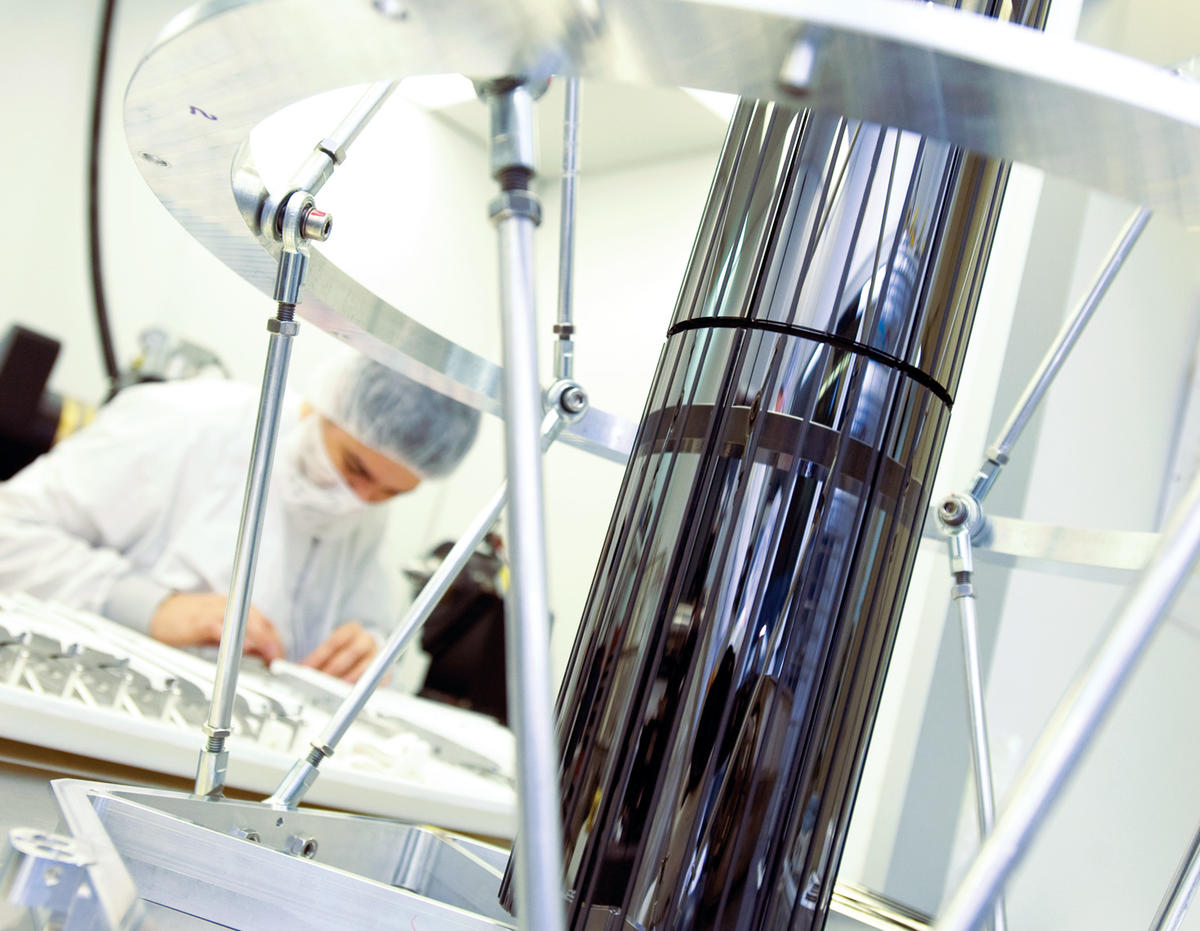 Scientist in lab behind telescope