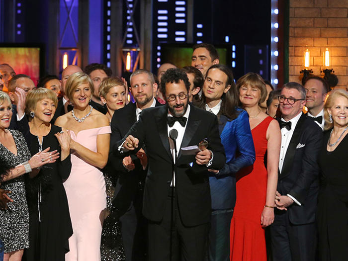 Playwright Tony Kushner, center, and the cast and crew of "Angels in America" accept the award for best revival of a play at the 72nd annual Tony Awards at Radio City Music Hall on Sunday, June 10, 2018, in New York. (Photo by Michael Zorn/Invision/AP)