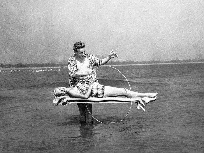 Black and white photo of a magician practicing levitation in Lake Michigan during the summer of 1955