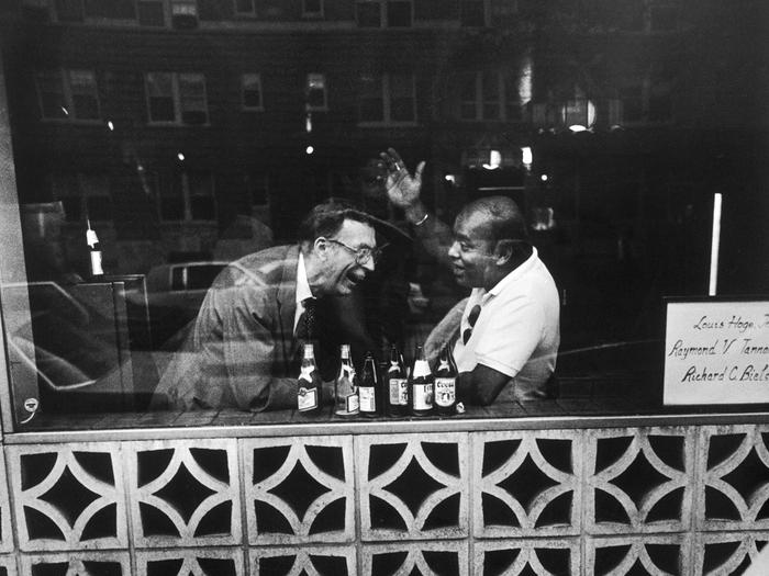 Photograph of two men in a bar by Jack Eisenberg