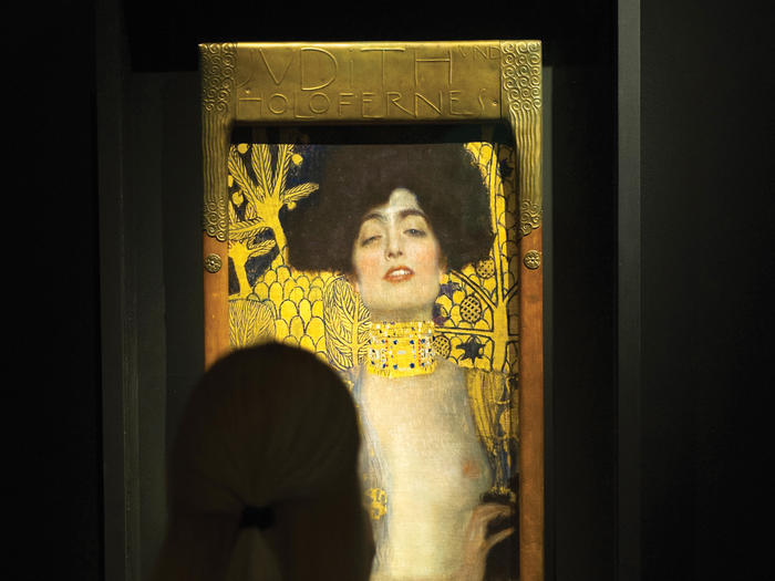 A person looking at "Judith I" by Gustav Klimt
