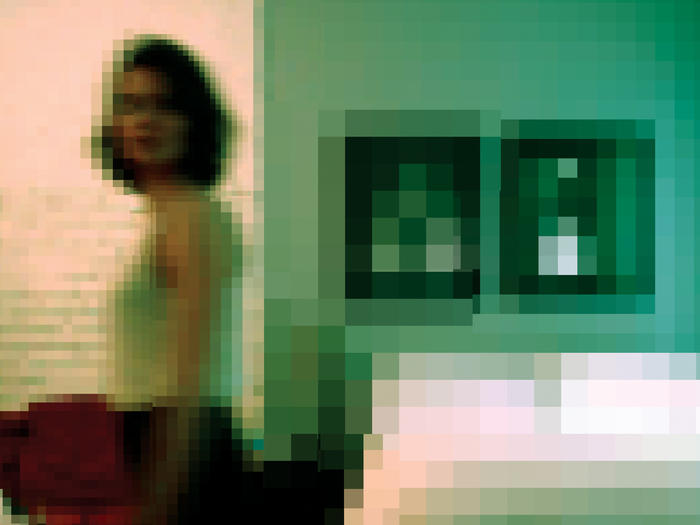 Pixelated photo of woman in a bedroom