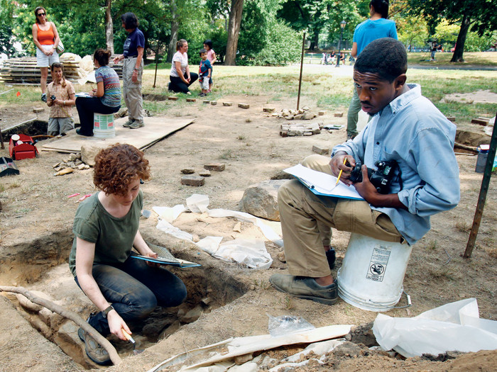 Madeline Landry and Ashton Dorminvil researching the remains of Seneca Village