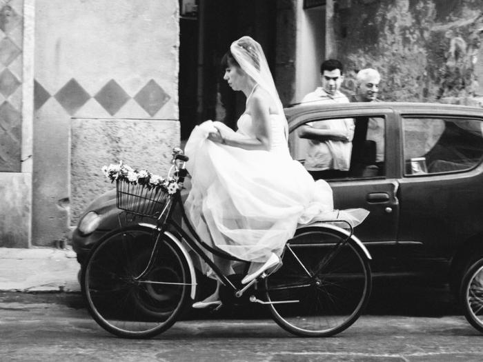 Black and white photo of bride riding bicycle: "Bridecycle" by Pan Su "Peter" Kim