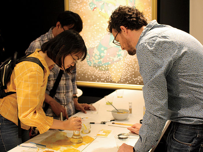 Students at Columbia's Center for Science and Society mix pigments at the Sato Sakura Gallery