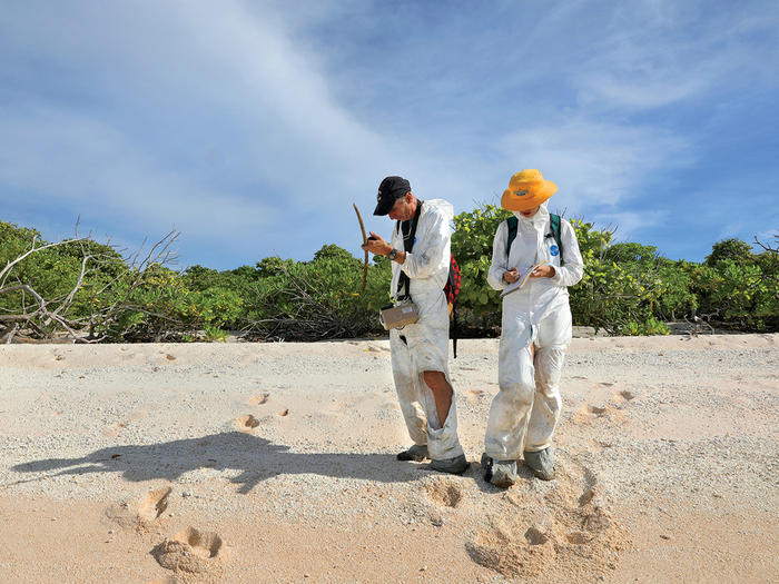 Columbia scientists Emlyn Hughes and Gemma Sahwell collecting soil samples on the Marshall Islands to test for radiation