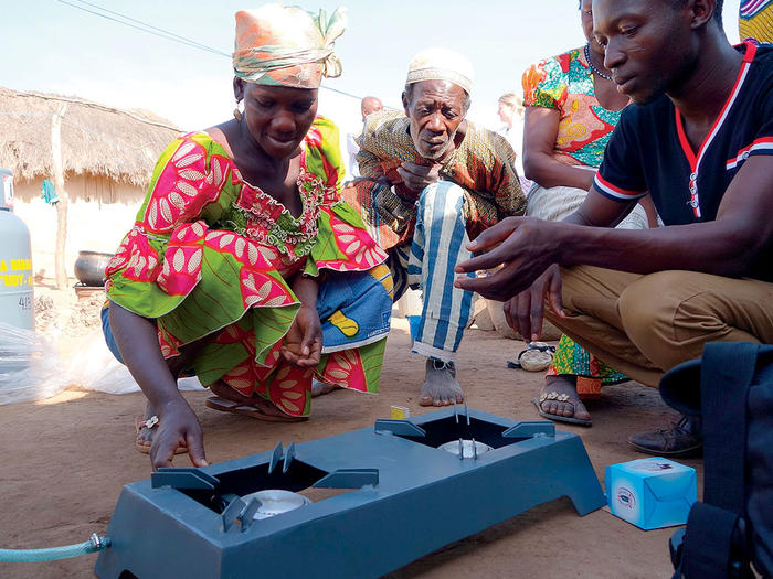 People in Ghana installing a low-emissions stove