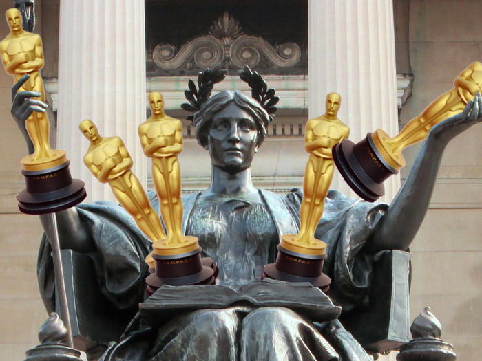 Columbia Alma Mater statue holding Oscar statues