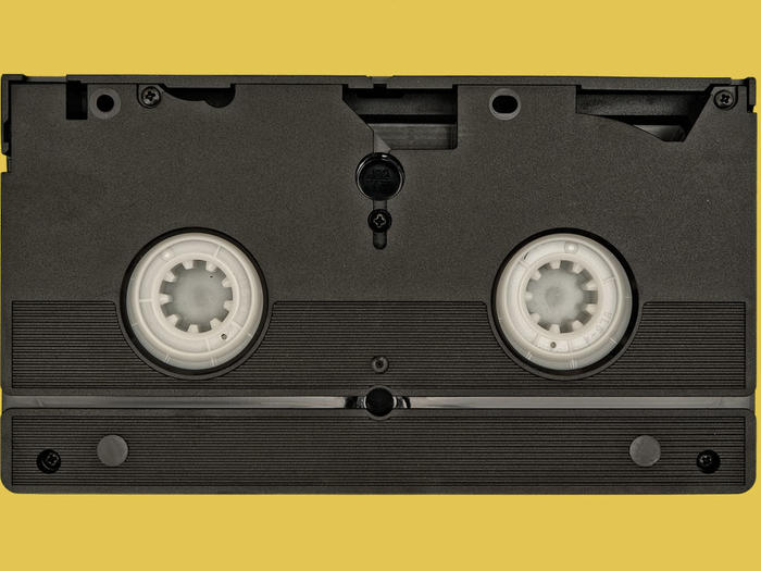 Video cassette over yellow background