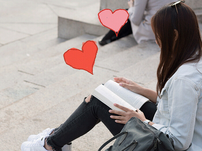 Columbia student reading book on Low Library steps