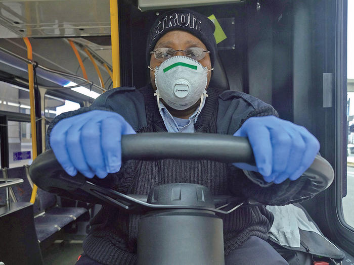 A city bus driver in Detroit wearing a face mask