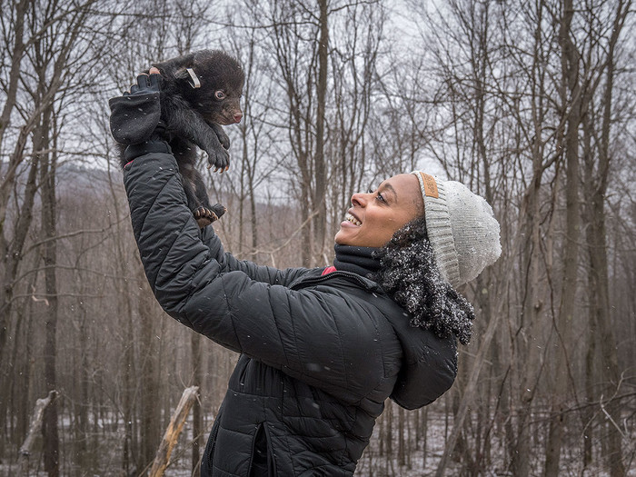 Wildlife ecologist Rae Wynn-Grant holding a baby black bear