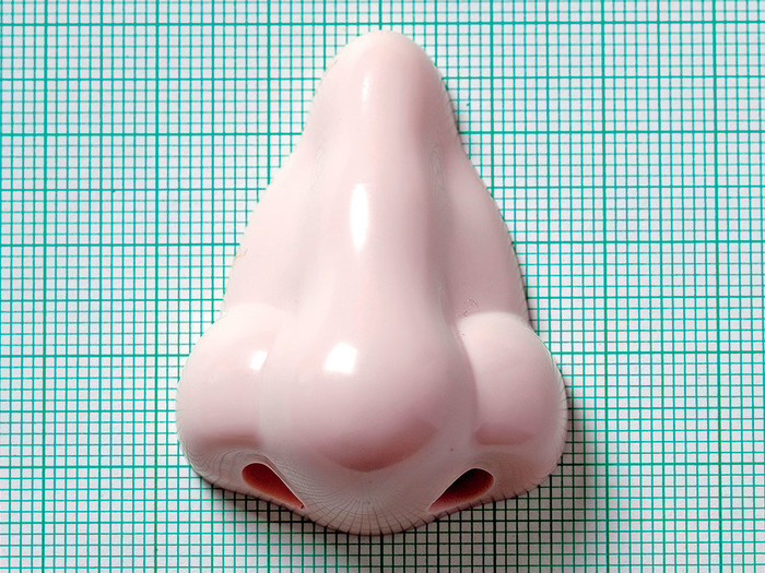 A plastic nose over grid background