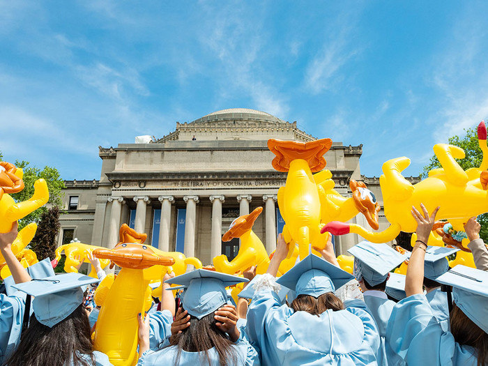 Columbia College graduates waving inflatable Roar-ee lions on 2022 Commencement Day