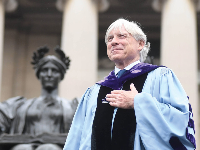 Columbia University president Lee C. Bollinger in front of Alma Mater statue on Low Library steps