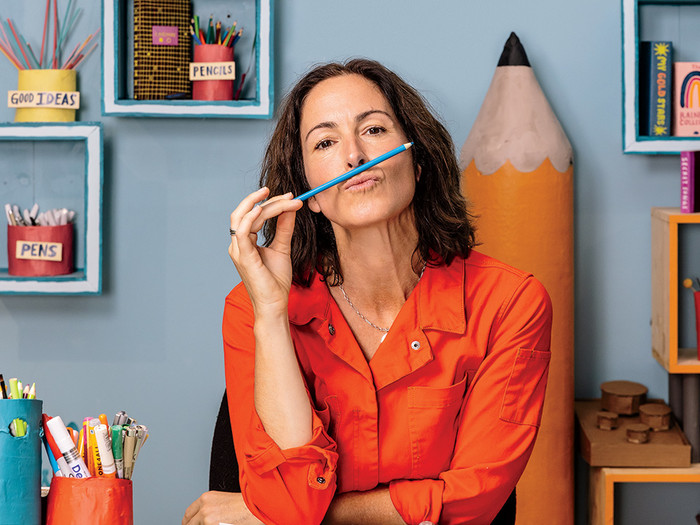 Illustrator Wendy MacNaughton with pencils in an art studio