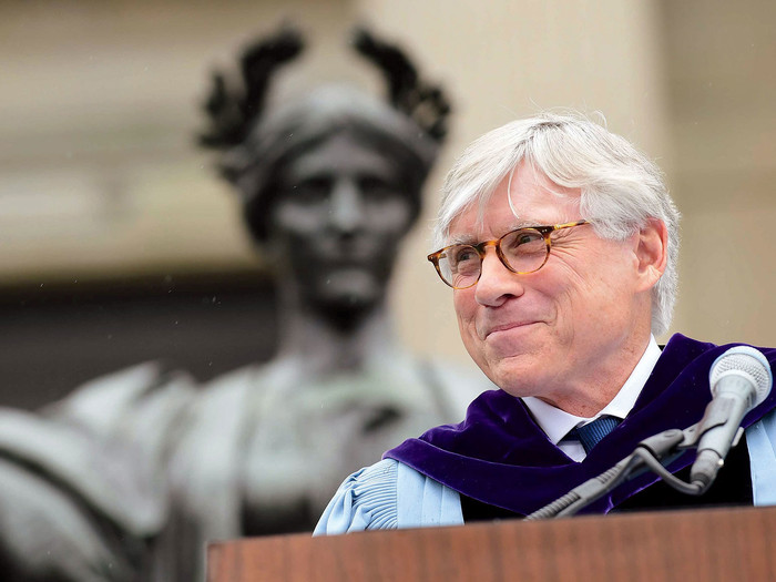 Columbia University president Lee C. Bollinger in front of Alma Mater statue on Low Library steps