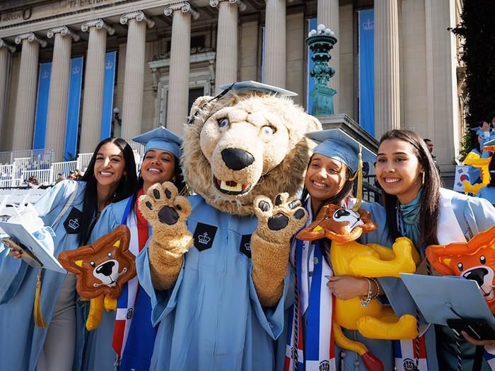 Graduating Columbia students pose with Roar-ee mascot at 2023 Commencement
