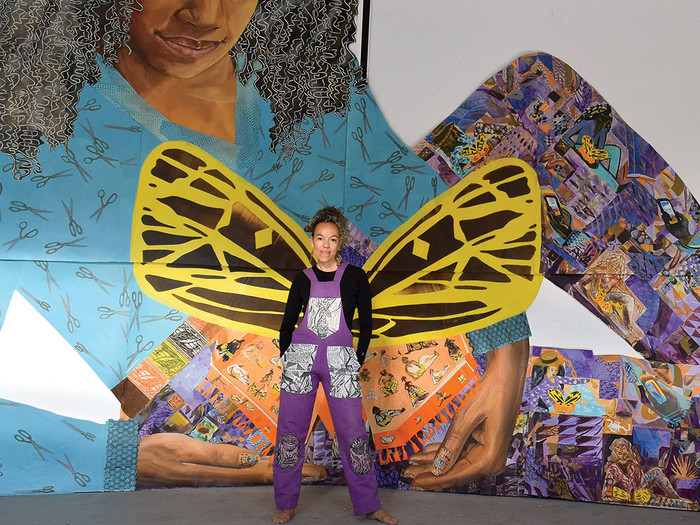Artist Paula Wilson in front of an art installation 