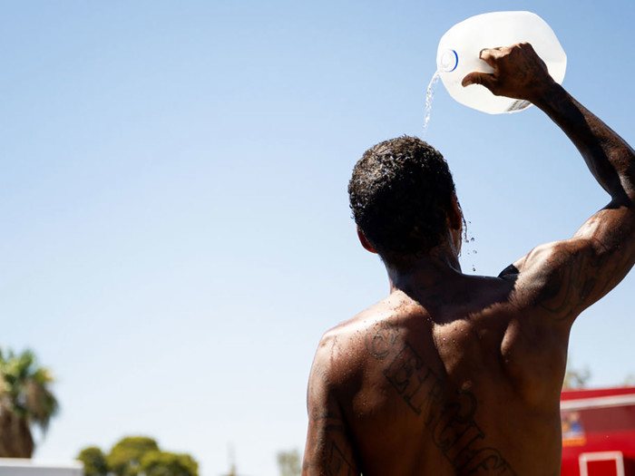 A man cools of with water in the Southwest