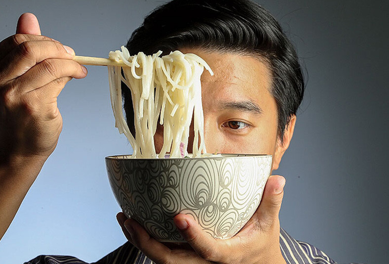 Houston Chronicle restaurant critic Bao Ong with a bowl of ramen