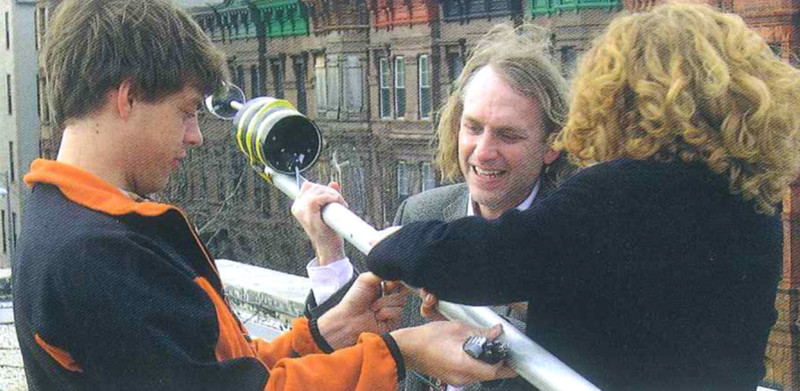 Columbia environmental scientist Wade McGillis, center, helps graduate students install wind-sending equipment atop the Hans Christian Anderson School in Harlem
