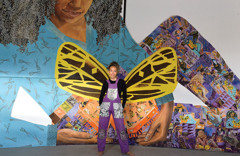 Artist Paula Wilson in front of an art installation