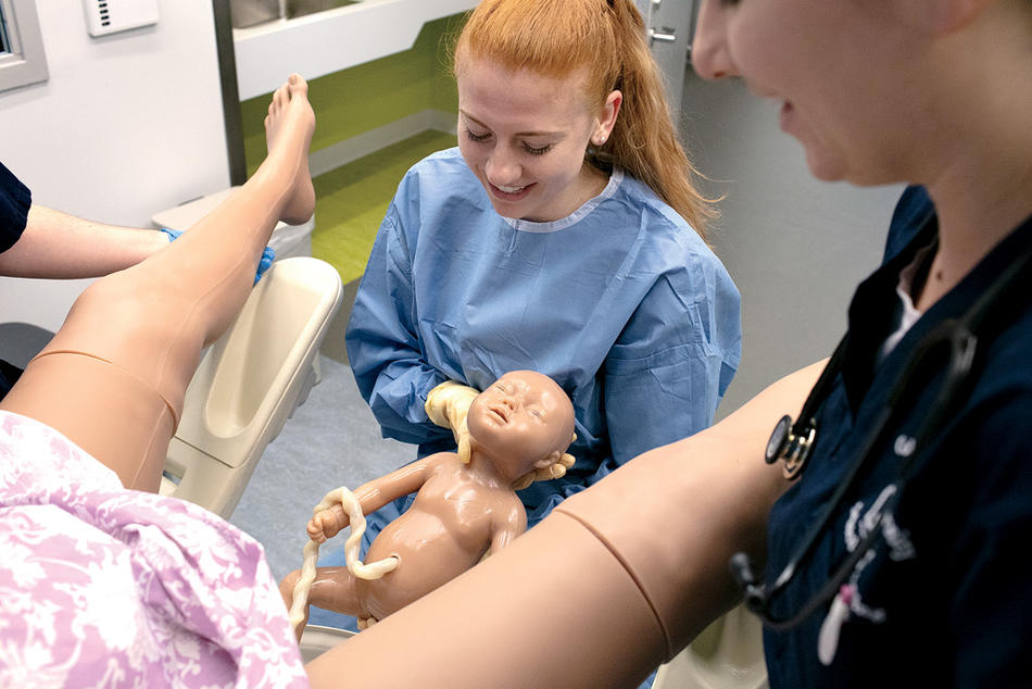 Jenna Wetzel, below, a doctoral student in the nurse-midwifery program, delivering a robot baby at the Columbia Nursing School simulation center.