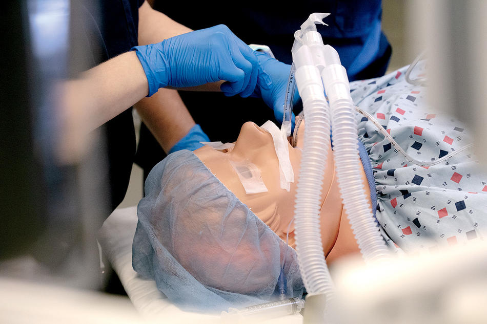 Students in Columbia Nursing School’s nurse-anesthesia program sedate a robot for surgery. 
