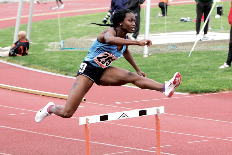 Kyra Caldwell jumping over a hurdle