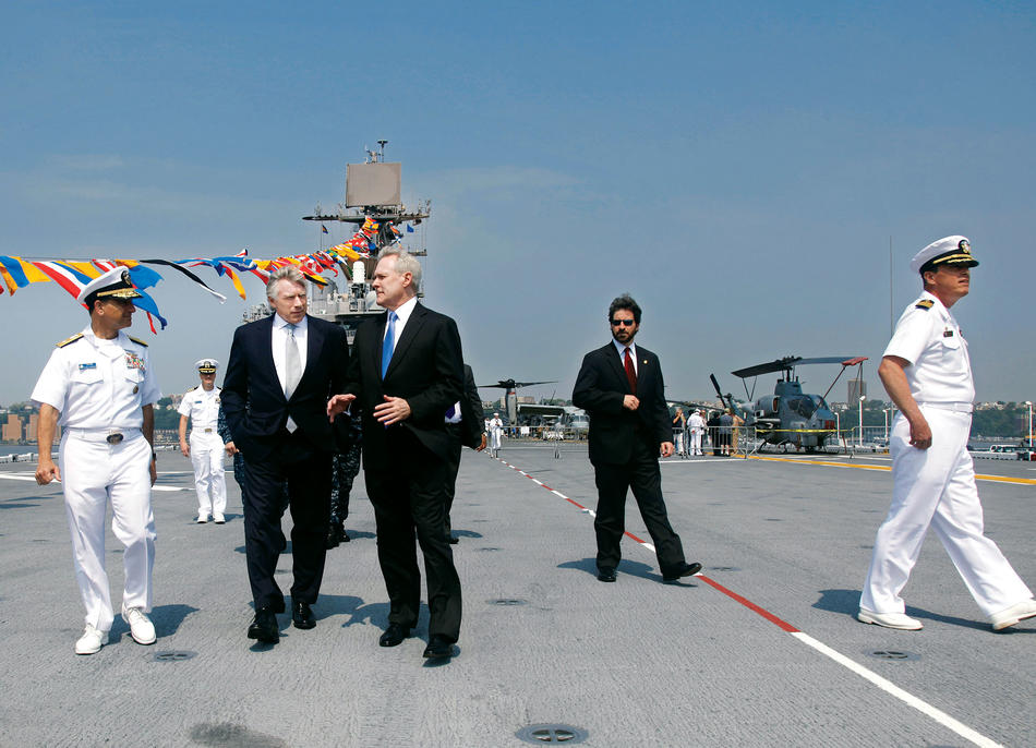 Rear Admiral Herman Shelanski, at left, escorts President Bollinger and Navy Secretary Ray Mabus onto the deck of the USS Iwo Jima
