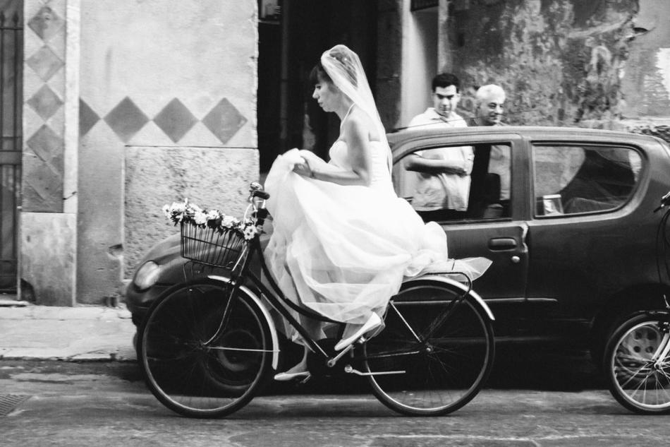 Black and white photo of bride riding bicycle: "Bridecycle" by Pan Su "Peter" Kim