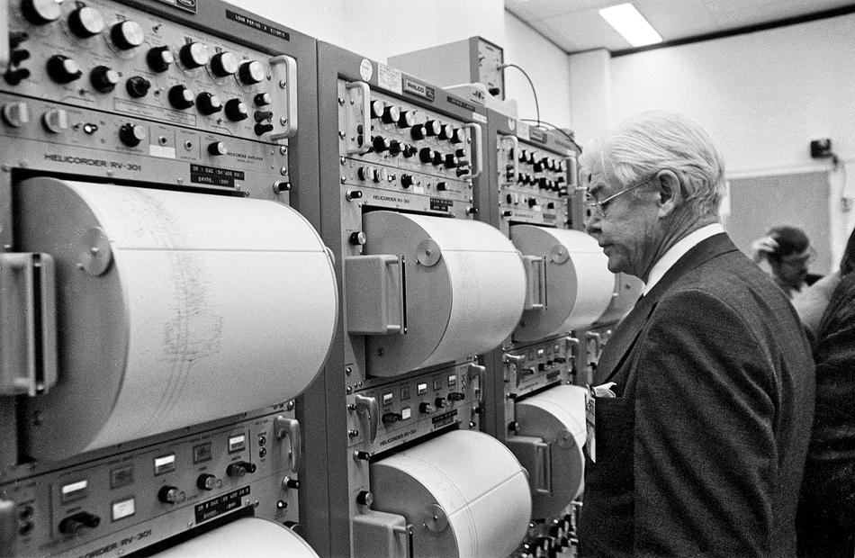 Maurice Ewing examines seismographic readings from the impact of a Saturn S-IVB rocket on the moon. (NASA)