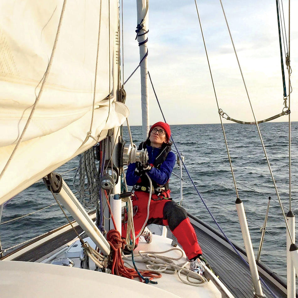 Agustina Besada hoisting a sail on her sailboat