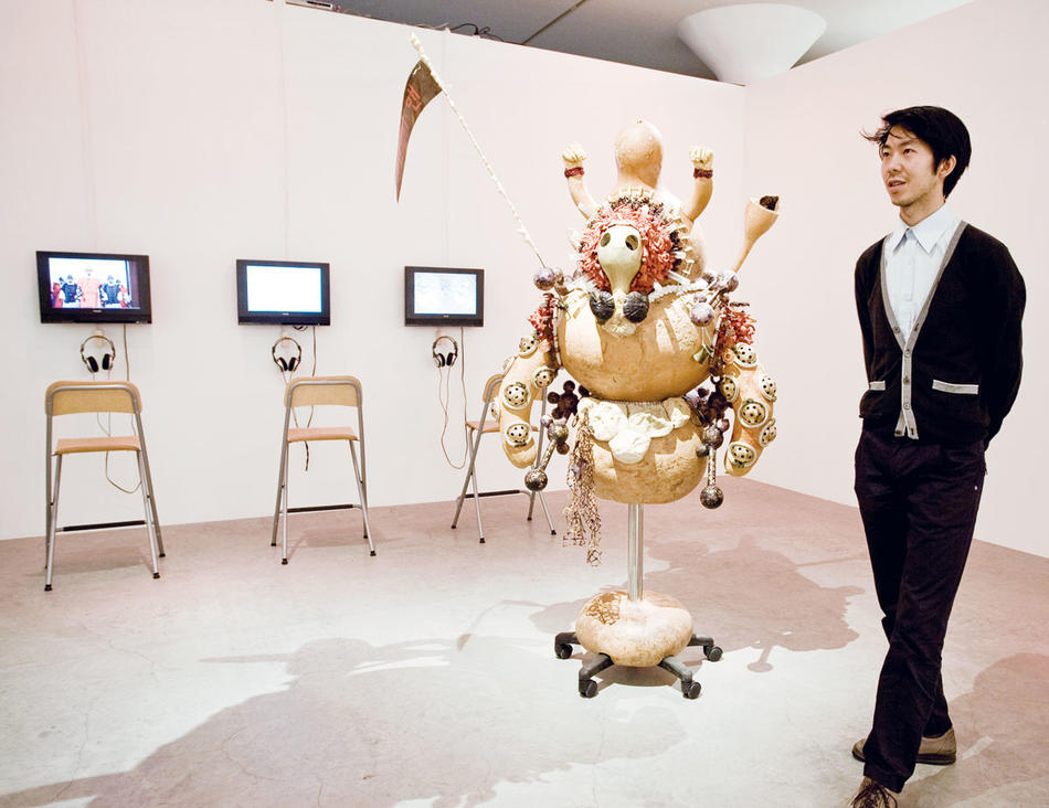 "Everyman Armor: In Remembrance of Kim Kim Kim," by R&D (North Korean gourds, eggplant skins, red-pepper paste, plastic, copper, steel, glue, etc.) Shown with artist Robert Rhee.