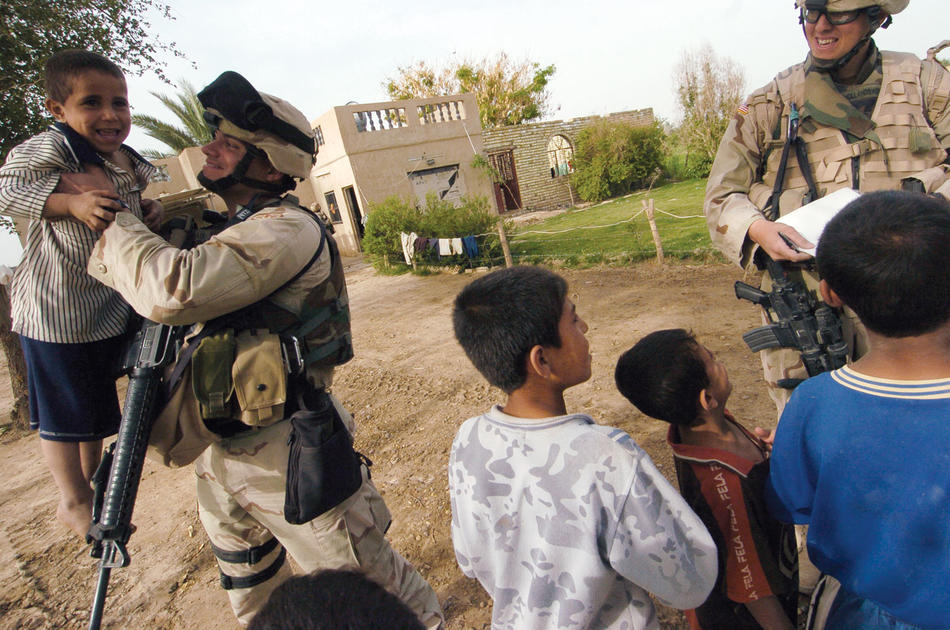 Luis Carlos Montalvan with local children during a reconnaissance mission in southern Baghdad in 2005