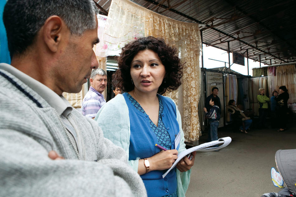 Sholpan Primbetova interviews a worder in Barakholka Market near Almaty, Kazakhstan. (David Trilling)